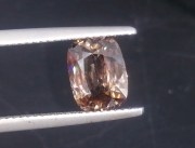 affordable and cheap 3 carats unheated orangish beige cushion shiny natural Zircon from Pailin Cambodia. 