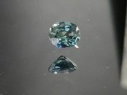 Green oval sapphire with dashes of blue, very clean and shiny small sapphire from Thailand. 