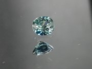 Green oval sapphire with dashes of blue, very clean and shiny small sapphire from Thailand. 