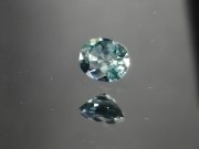 Green oval sapphire with dashes of blue, very clean and shiny small sapphire from Thailand. 