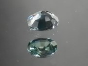 Green oval sapphire with dashes of blue, very clean and shiny small sapphire from Thailand. 