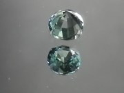 Green oval sapphire with dashes of blue, very clean and shiny small sapphire from Thailand. 